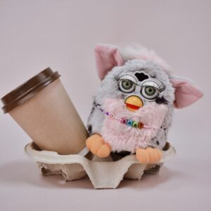 a stuffed animal holding a cup of coffee